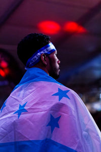 Michael Martinez wearing a headband and draped his flag before war.