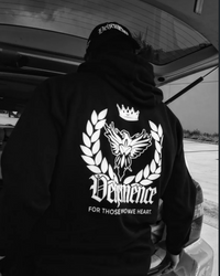 Romero wearing a Vehemence hoodie with a our family crest logo.