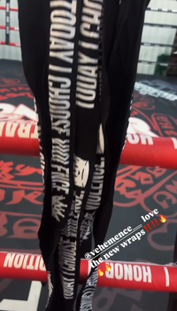 Black handwraps hanigng from ring side