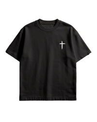 Black t-shirt with a white cross design on a concrete floor background